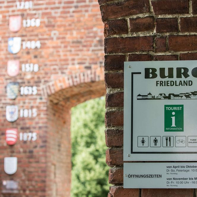 Entrance to the historic Streleburg Friedland (Lower Lusatia) with a sign and coat of arms